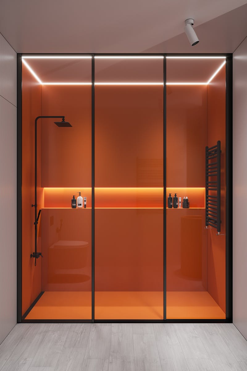 Sleek modern shower with orange glass panels, minimalistic and elegant.